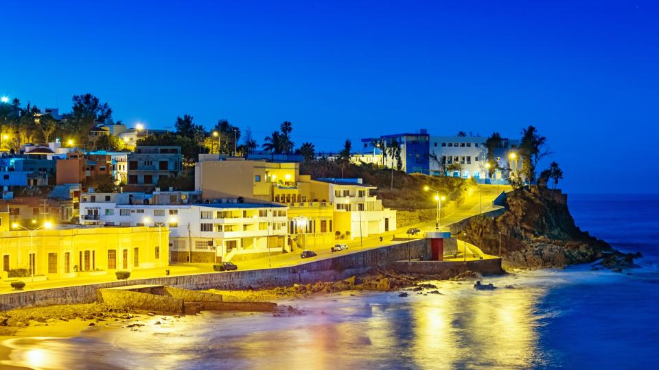 photograph of the illuminated waterfront in Mazatlan, Sinaloa, Mexico at twilight blue hour.