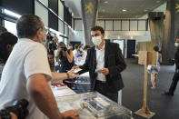 Green Party Europe-Ecologie-Les Verts (EELV) Gregory Doucet, candidate in the second round of the municipal elections, prepares to vote in Lyon, central France, Sunday, June 28, 2020. France is holding the second round of municipal elections in 5,000 towns and cities Sunday that got postponed due to the country's coronavirus outbreak. (AP Photo/Laurent Cipriani)