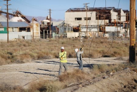 Linemen repair lines that were broken during a powerful earthquake that struck Southern California