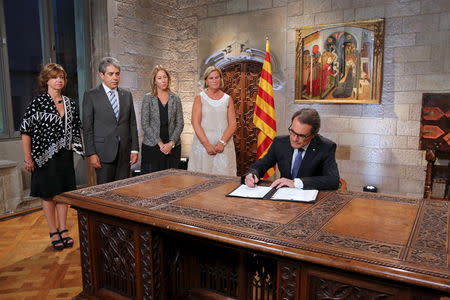 Catalonia's regional president Artur Mas (R) signs a decree calling for the region's elections to be held on September 27 at Palau de la Generalitat in Barcelona, Spain, August 3, 2015, in this handout courtesy of the Catalonian regional government. REUTERS/Ruben Moreno Garcia/Generalitat de Catalunya/Handout via Reuters