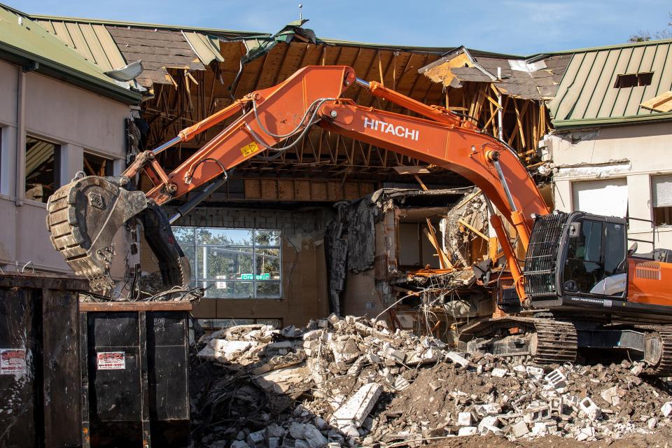 A demolition excavator tears down the 85-year-old former headquarters of Florida Citrus Mutual in downtown Lakeland on Thursday.
