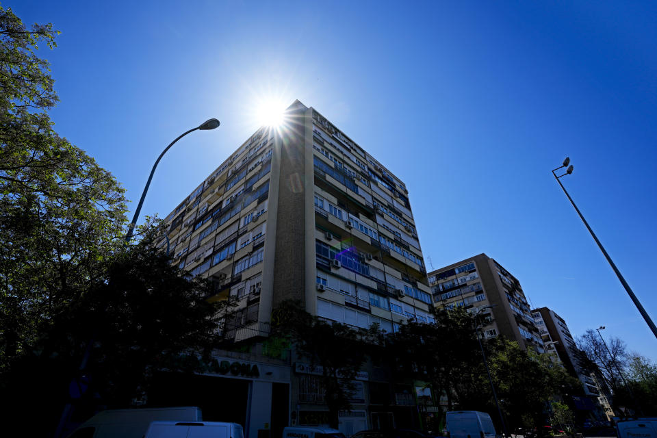 The sun shines from behind housing blocks in Madrid, Spain, Tuesday, April 18, 2023. Spain's leftist coalition government has approved a plan to make available some 50,000 houses for rent at affordable prices as part of measures aimed at curbing soaring rents and house prices. The apartments will come from the state-controlled SAREB 'bad bank' that was set up in 2012 to relieve troubled banks of their most toxic assets during the international financial crisis. (AP Photo/Paul White)