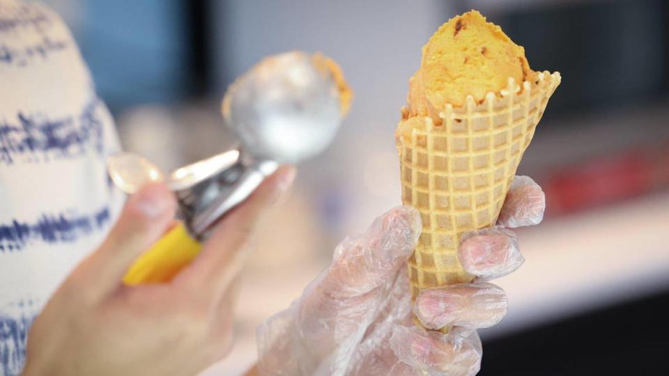 Max Bundy scoops ice cream into a waffle cone at SLO à la Mode, which took the place of the former Doc Burnstein’s Ice Cream Lab location in downtown San Luis Obispo in July 2023.