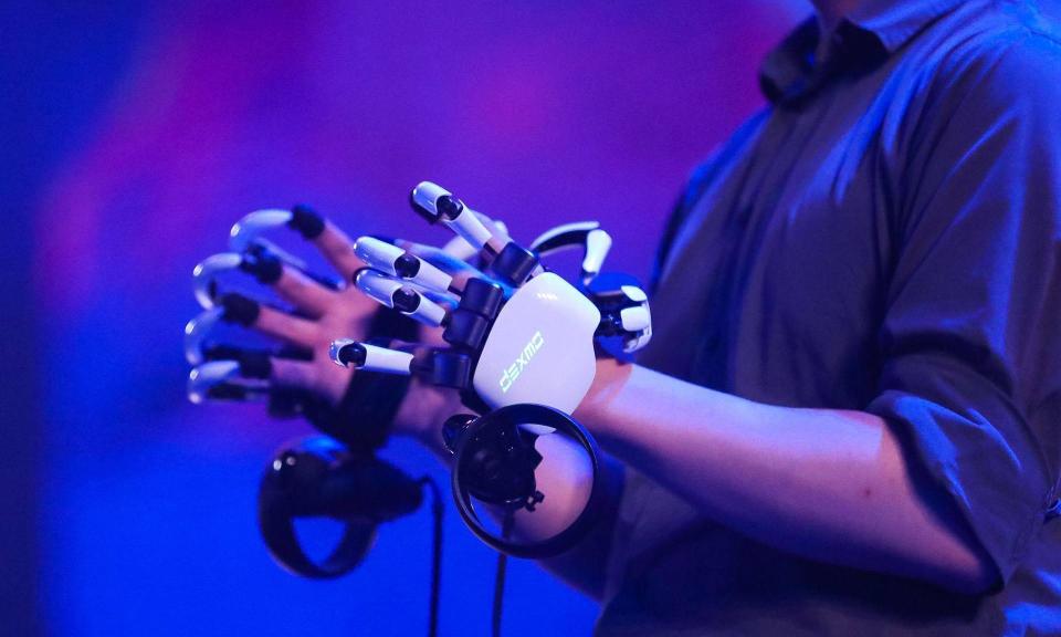 <span>‘When you scroll your fingers through a virtual brick, you can feel the texture of the surface’: the Dexmo force feedback glove from Dexta Robotics.</span><span>Photograph: VPhoto/Dexta Robotics</span>