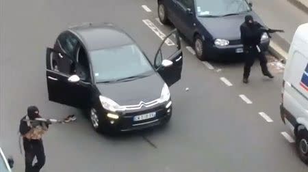 Gunmen flee the offices of French satirical newspaper Charlie Hebdo in Paris, in this still image taken from amateur video shot on January 7, 2015, and obtained by Reuters. REUTERS/Handout via Reuters TV