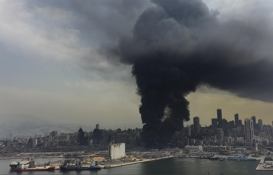 Black smoke rise from a fire at warehouses at the seaport of Beirut, Lebanon, Thursday, Sept. 10. 2020. A huge fire broke out Thursday at the Port of Beirut, triggering panic among residents traumatized by last month's massive explosion that killed and injured thousands of people. (AP Photo/Hussein Malla)