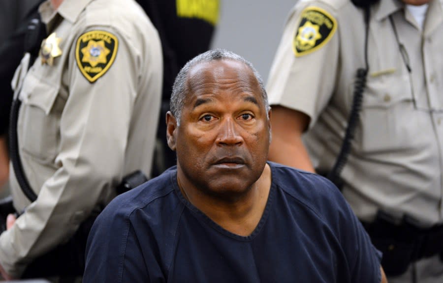 FILE – In this May 14, 2013, file photo, O.J. Simpson sits during a break on the second day of an evidentiary hearing in Clark County District Court in Las Vegas. Simpson, the decorated football superstar and Hollywood actor who was acquitted of charges he killed his former wife and her friend but later found liable in a separate civil trial, has died. He was 76. (AP Photo/Ethan Miller, Pool, File)