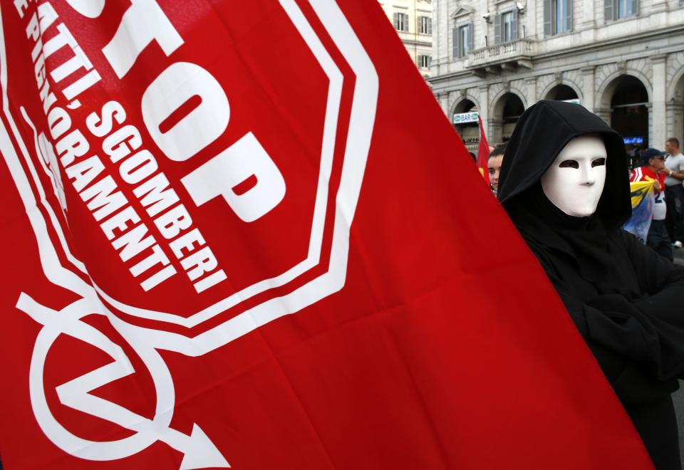 A demonstrator wears a mask during a protest in downtown Rome