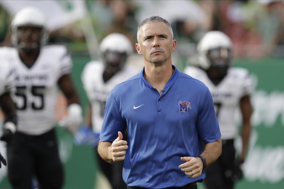 Memphis head coach Mike Norvell runs onto the field during the first half of an NCAA college football game against South Florida Saturday, Nov. 23, 2019, in Tampa, Fla. (AP Photo/Chris O'Meara)