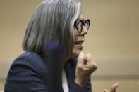 Prosecutor Maria Schneider makes a stabbing motion, describing the wounds the victim suffered, as she makes her opening statement in the murder trial of Dayonte Resiles at the Broward County Courthouse on Wednesday, Nov. 17, 2021, in Fort Lauderdale, Fla. Resiles is accused in the 2014 stabbing death of Jill Halliburton Su in her Davie home. After his initial arrest, Resiles escaped custody and led investigators on a 6-day manhunt. (Amy Beth Bennett/South Florida Sun-Sentinel via AP)