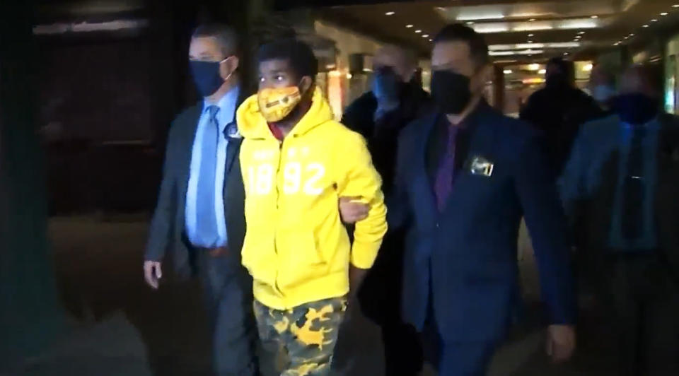 Police lead Khari Covington away from the NYPD station in the Coney Island subway station on Jan. 6, 2021, in Brooklyn. (WNBC)