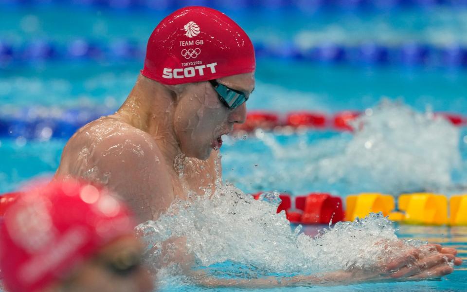 Duncan Scott of Britain swims in a heat of the men's 200-meter individual medley at the 2020 Summer Olympics, - AP