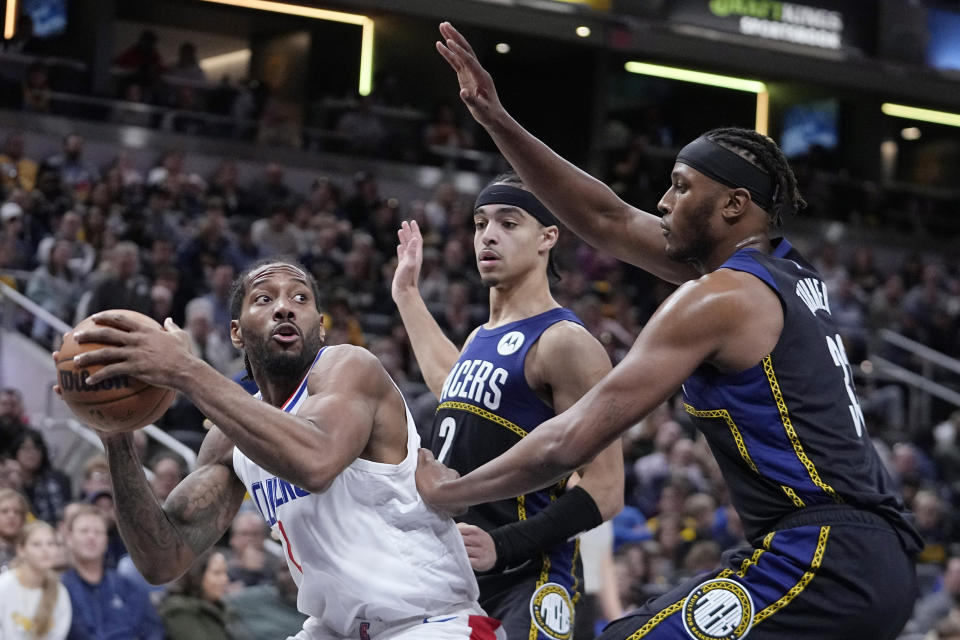 LA Clippers' Kawhi Leonard (2) puts up a shot against Indiana Pacers' Myles Turner (33) during the second half of an NBA basketball game, Saturday, Dec. 31, 2022, in Indianapolis. (AP Photo/Darron Cummings)