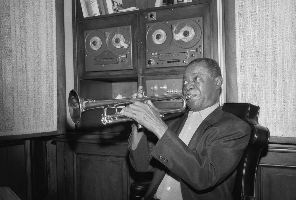 Famous trumpeter, Louis Armstrong (1901-1971), playing his trumpet in a recording studio in 1969.