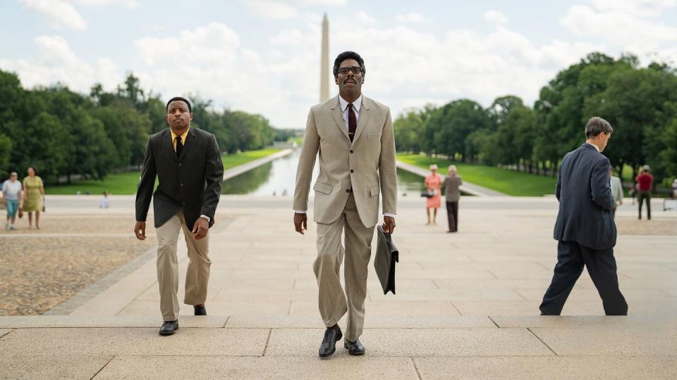 colman domingo carrying a briefcase and walking in washington dc in a scene from the movie rustin