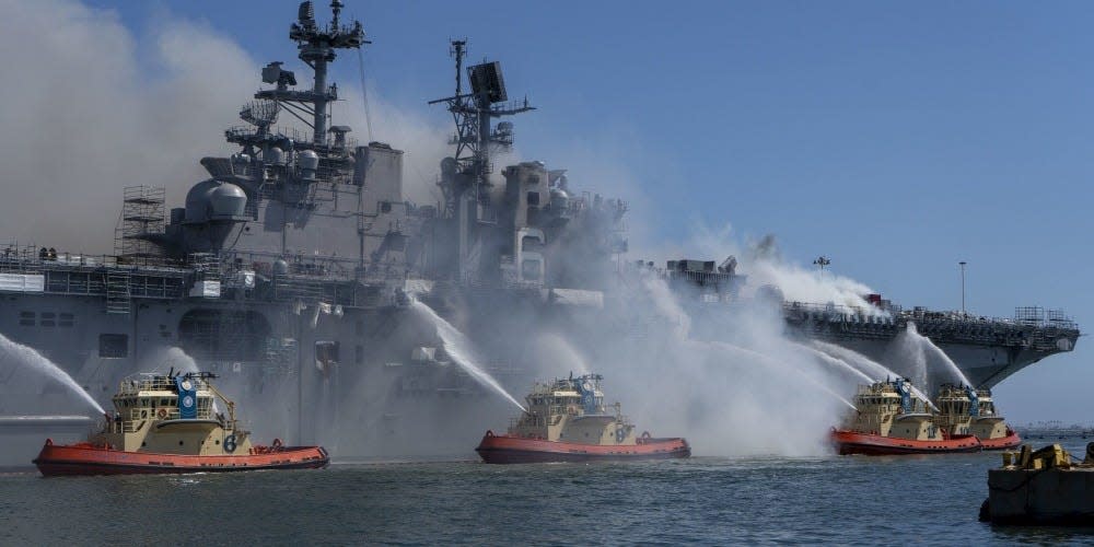 Firefighters battle a fire aboard the US Navy amphibious assault ship USS Bonhomme Richard