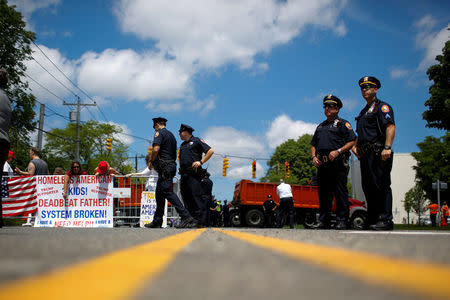 New York Police stand guard at the street before the U.S. president Trump arrival during a forum about Central American-based Mara Salvatrucha (MS-13) gang organization at the Morrelly Homeland Security Center in Bethpage, New York, U.S., May 23, 2018. REUTERS/Eduardo Munoz