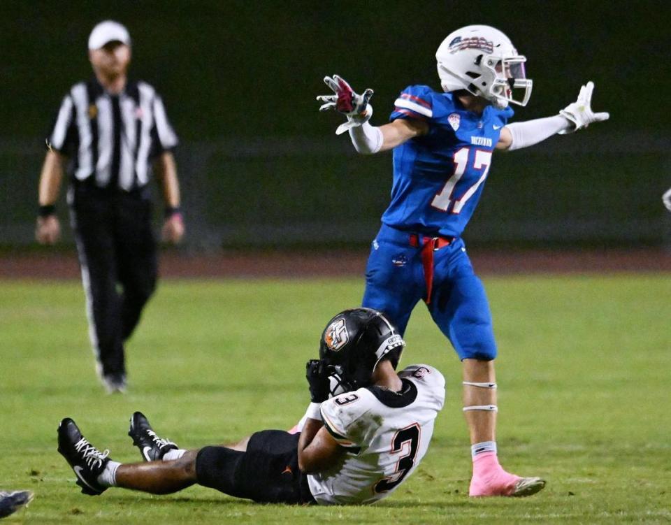 Buchanan’s Landon Burger, right, after breaking up a pass to Central’s Daylon Scott, sitting on the ground, Thursday, Oct. 5, 2023 in Clovis.