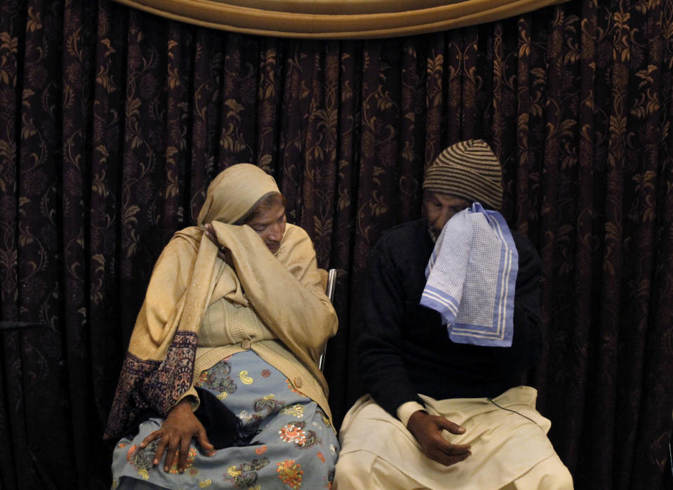 In this Friday, Jan. 10, 2014, photo, Pakistani Christians, Naseema Bibi, left and Anwar Masih, parents of a blasphemy law victim Asif Peraiz, who was arrested on Oct. 9, 2013, wipe their tears during an interview in Lahore, Pakistan. Pakistan’s blasphemy law has become a potent weapon in the arsenal of Muslim extremists, who use it against adherents of minority religions. (AP Photo/Anjum Naveed)