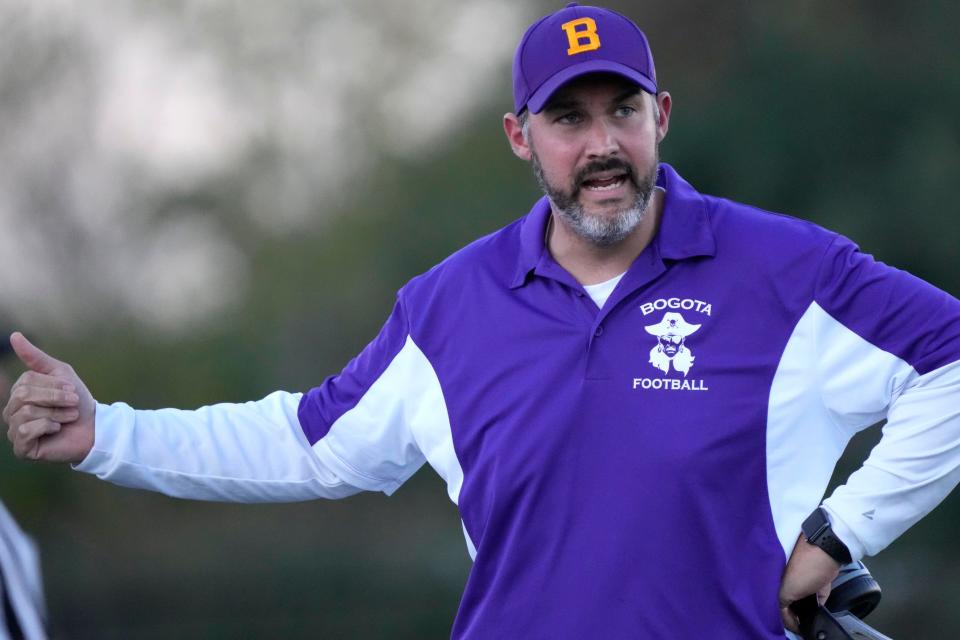 Bogota Head Football Coach, Brian Appleton, gives instructions to his team, in Palisades Park. Thursday, October 6, 2022