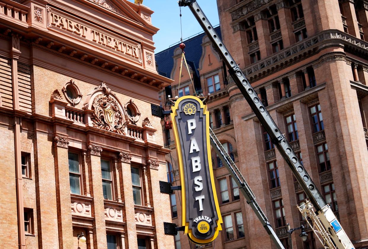 A work crew installs a new blade sign for the Pabst Theater on Monday, May 15 2023  at the corner of corner of Water and Wells Streets  in downtown Milwaukee. The sign is 7’ wide x 27’ tall. The project is expected to take a full day to complete.