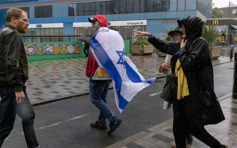 A man draped in an Israel flag attends a Jeremy Corbyn rally