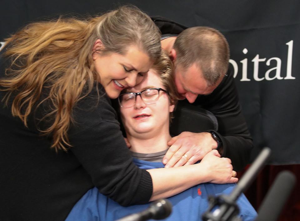 Cayden Winstead is hugged by his mother, Leslee, and father, Chris, after they found out that they are getting an all-expenses-paid trip to the Super Bowl on January 18, 2023.  The gift came from Goose Flights, a charitable organization founded by late football player, Tony Siragusa and awarded by his children.  Winstead sustained a brain injury and is recovering.  The Super Bowl coincides with the date that Winstead was injured.