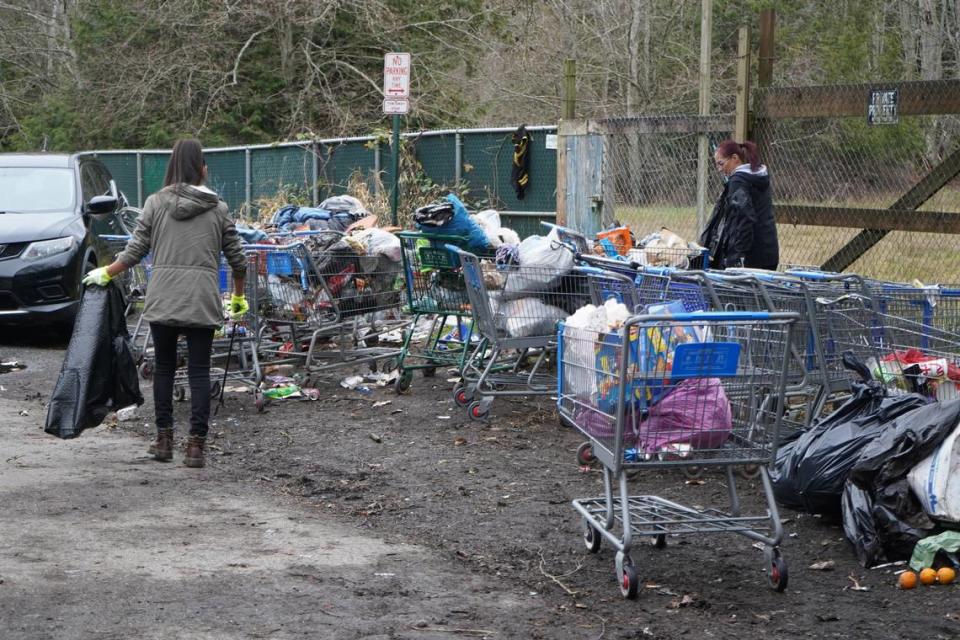 Volunteers joined residents of the encampment behind Walmart to help clean up trash on Dec. 29, 2023, in Bellingham, Wash. Rachel Showalter/The Bellingham Herald