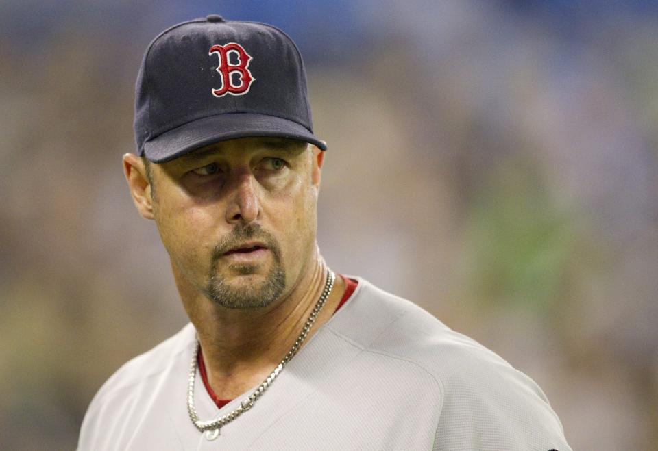 FILE - Boston Red Sox starting pitcher Tim Wakefield leaves the field after working against the Toronto Blue Jays in a Sept. 7, 2011 baseball game in Toronto. Wakefield, the knuckleballing workhorse of the Red Sox pitching staff who bounced back after giving up a season-ending home run to the Yankees in the 2003 playoffs to help Boston win its curse-busting World Series title the following year, has died. He was 57. The Red Sox announced his death in a statement Sunday, Oct. 1 2023, (Darren Calabrese/Canadian Press via AP, file)