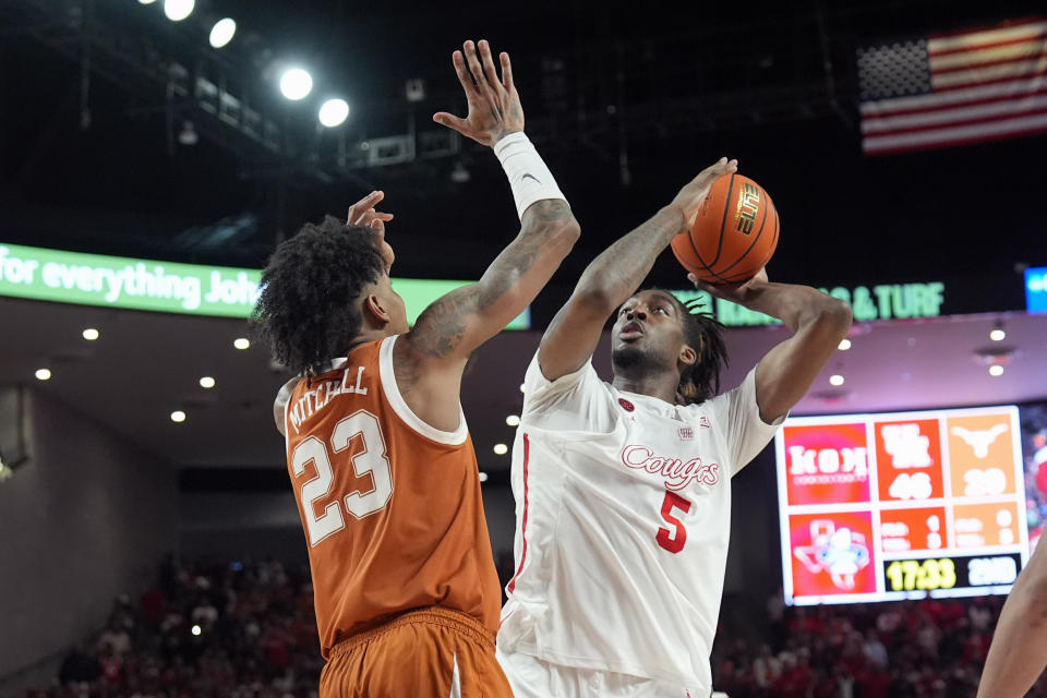 Houston's Ja'Vier Francis (5) shoots as Texas' Dillon Mitchell (23) defends during the second half of an NCAA college basketball game Saturday, Feb. 17, 2024, in Houston. Houston won 82-61. (AP Photo/David J. Phillip)