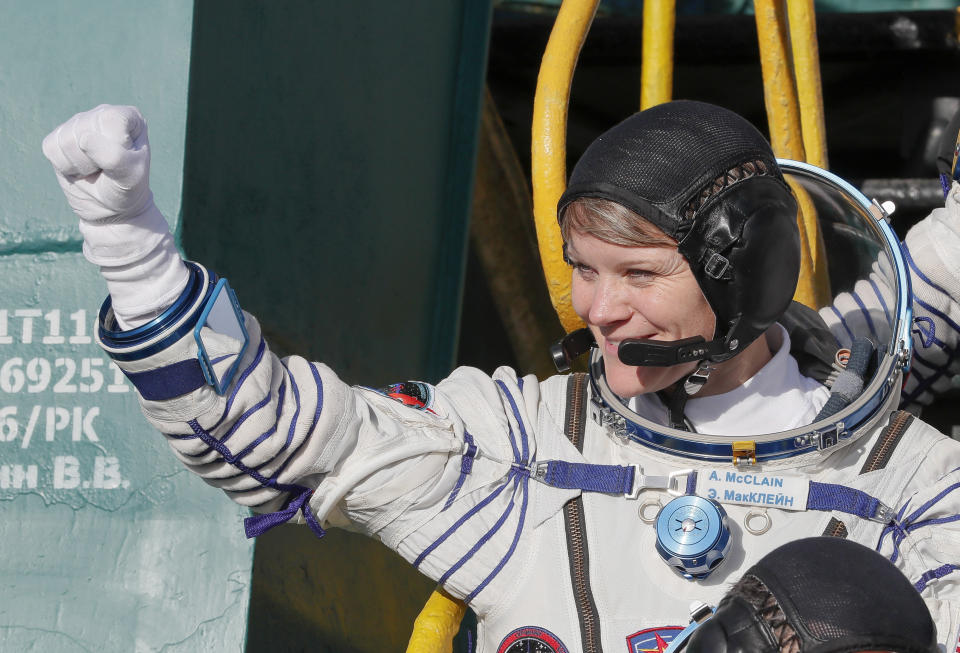 U.S. astronaut Anne McClain, crew member of the mission to the International Space Station, ISS, waves as she boards to the rocket prior to the launch of Soyuz-FG rocket at the Russian leased Baikonur cosmodrome, Kazakhstan, Monday, Dec. 3, 2018. (AP Photo/Shamil Zhumatov, Pool)