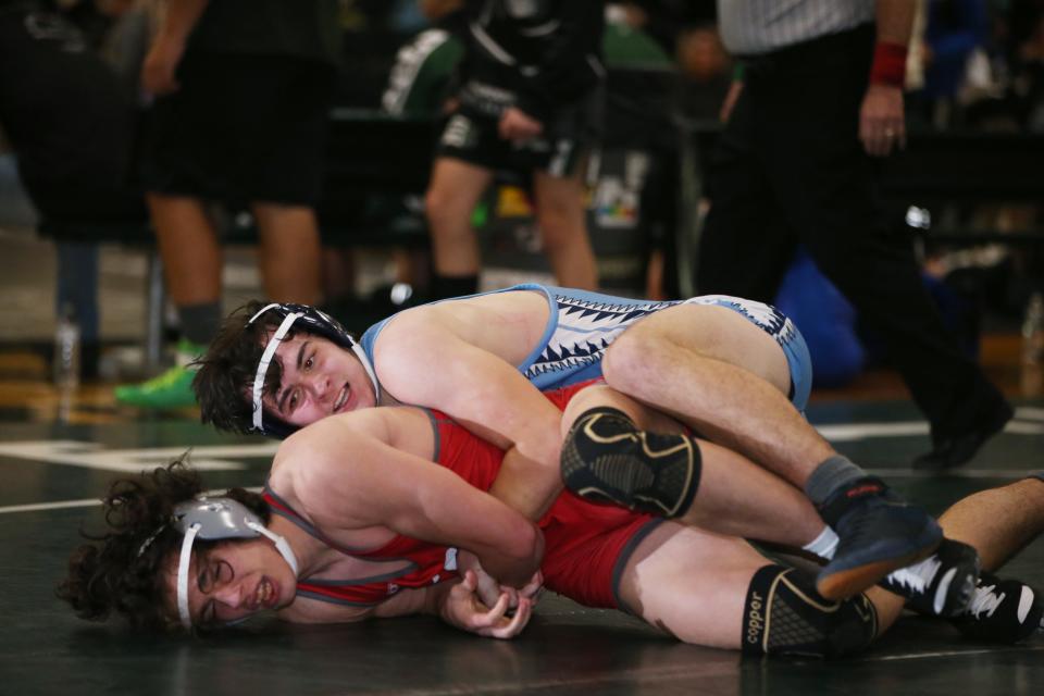 From top, Saugerties' James Burns and Red Hook's Christian Totman wrestle in the 172 lb match during the Section 9 Duals final at Minisink Valley High School on January 11, 2023.