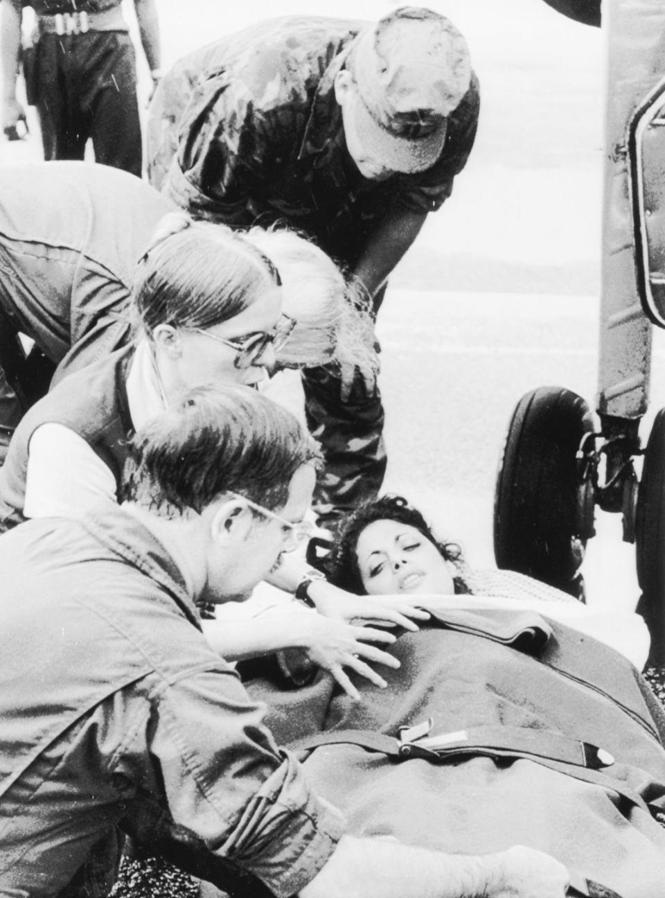 jackie speier lying on a stretcher after being taken off an airplane