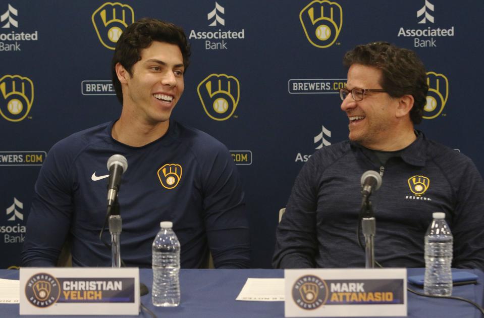 Brewers outfielder Christian Yelich shares a laugh with owner Mark Attanasio, during a news  conference to announce a seven-year contract extension for Yelich.