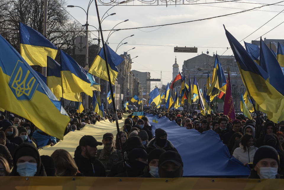 Demonstrators with Ukrainian national flags rally against Russian aggression in the center of Kharkiv, Ukraine's second-largest city, Saturday, Feb. 5, 2022, just 40 kilometers (25 miles) from some of the tens of thousands of Russian troops massed at the border of Ukraine. After weeks of talks in various diplomatic formats have led to no major concessions by Russia and the U.S., it's unclear how much impact the trips will have. But Ukraine's Foreign Minister Dmytro Kuleba said Friday that "top-level visits seriously reduce challenges in the sphere of security and upset the Kremlin's plans." (AP Photo/Evgeniy Maloletka)