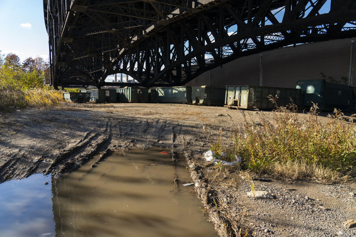 FILE - Dumpsters are stored under the Pulaski Skyway on Nov. 19, 2021, on the site of a former landfill where a new FBI investigation is taking place as a possible location where Teamsters union boss Jimmy Hoffa is buried in Jersey City, N.J. The FBI found no evidence of Hoffa during a search of land under the New Jersey bridge, a spokeswoman said Thursday, July 21, 2022. (AP Photo/Corey Sipkin, File)