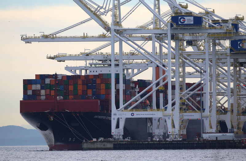 FILE PHOTO - Shipping containers are unloaded at Roberts Bank Superport in Delta, British Columbia, Canada January 15, 2018. Picture taken January 15, 2018. REUTERS/Ben Nelms