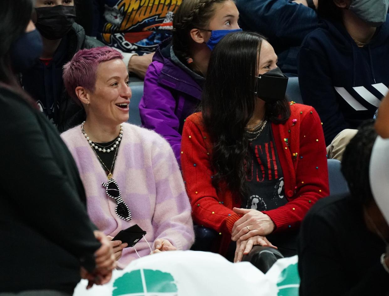 Megan Rapinoe and Sue Bird (right) attend a UConn-Notre Dame women's college basketball game.