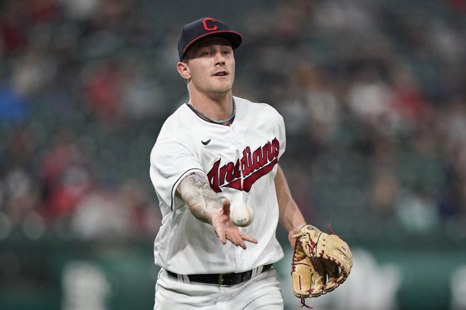 Cleveland Indians starting pitcher Zach Plesac tosses the ball to first base for the out on Detroit Tigers' Miguel Cabrera during the fourth inning in a baseball game Friday, April 9, 2021, in Cleveland. (AP Photo/Tony Dejak)