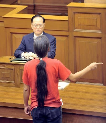 Leung Kwok-hung (standing) shouts at Chief Executive Donald Tsang during the leader's annual policy address in the Hong Kong Legislative Council chamber in 2008. Leung's activism has landed him in jail four times, and a new conviction, handed down in March for disorderly behaviour