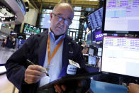 Trader Fred Reimer works on the floor of the New York Stock Exchange, Friday, July 19, 2019. U.S. stocks moved broadly higher in early trading on Wall Street Friday and chipped away at the week's losses. (AP Photo/Richard Drew)