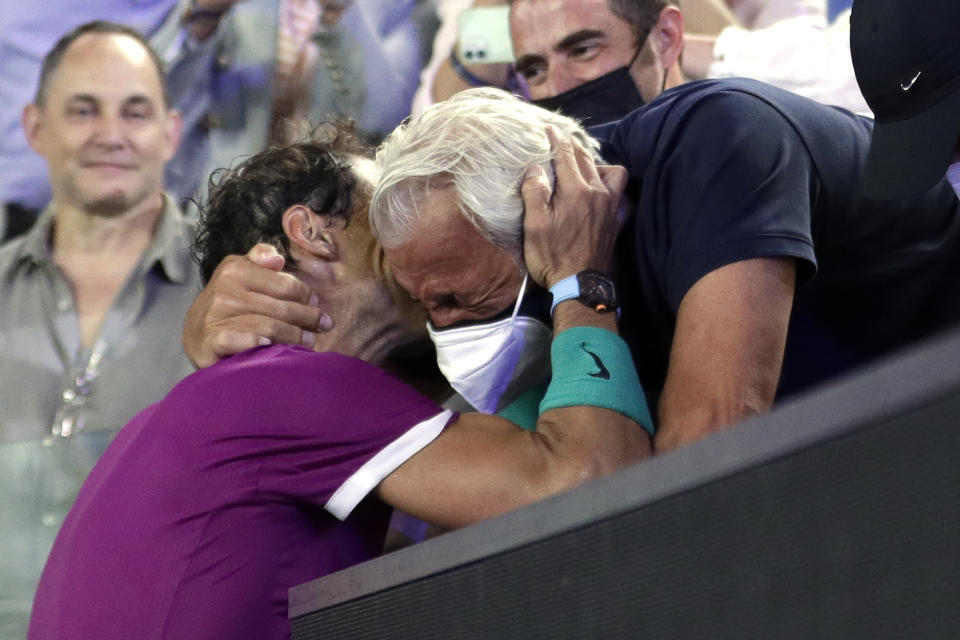 Rafael Nadal of Spain celebrates with his father Sebastian after his win over Daniil Medvedev of Russia in the men's singles final at the Australian Open tennis championships in Melbourne, Australia, early Monday, Jan. 31, 2022. (AP Photo/Hamish Blair)