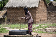 32 year old Marie Depaque, a mother of four children, draws water from a well at the village of Binmar, Chad, Friday, July 19, 2024. (AP Photo/Robert Bociaga)