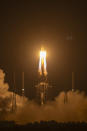 A Long March-5 rocket carrying the Chang'e 5 lunar mission lifts off at the Wenchang Space Launch Center in Wenchang in southern China's Hainan Province, early Tuesday, Nov. 24, 2020. China launched an ambitious mission on Tuesday to bring back material from the moon's surface for the first time in more than 40 years — an undertaking that could boost human understanding of the moon and of the solar system more generally. (AP Photo/Mark Schiefelbein)