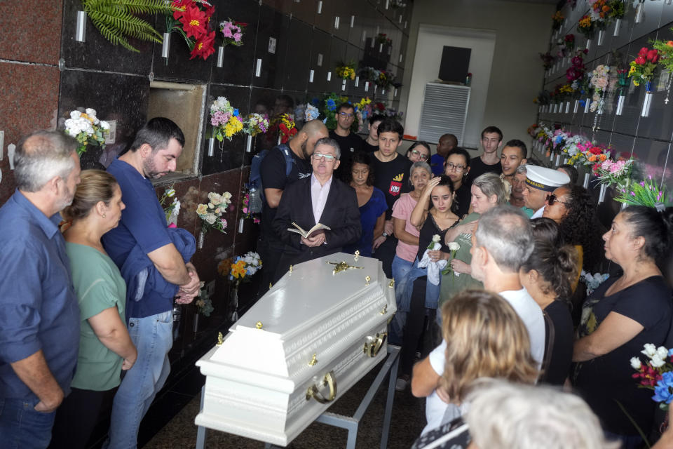 Friends and relatives attend the funeral of five-year-old Bernardo Machado who was killed by a man with a hatchet inside a day care center, at the Sao Jose cemetery in Blumenau, Santa Catarina state, Brazil, Thursday, April 6, 2023. A man with a hatchet jumped over a wall and burst into a day care center Wednesday in Brazil, killing four children, authorities said. (AP Photo/Andre Penner)