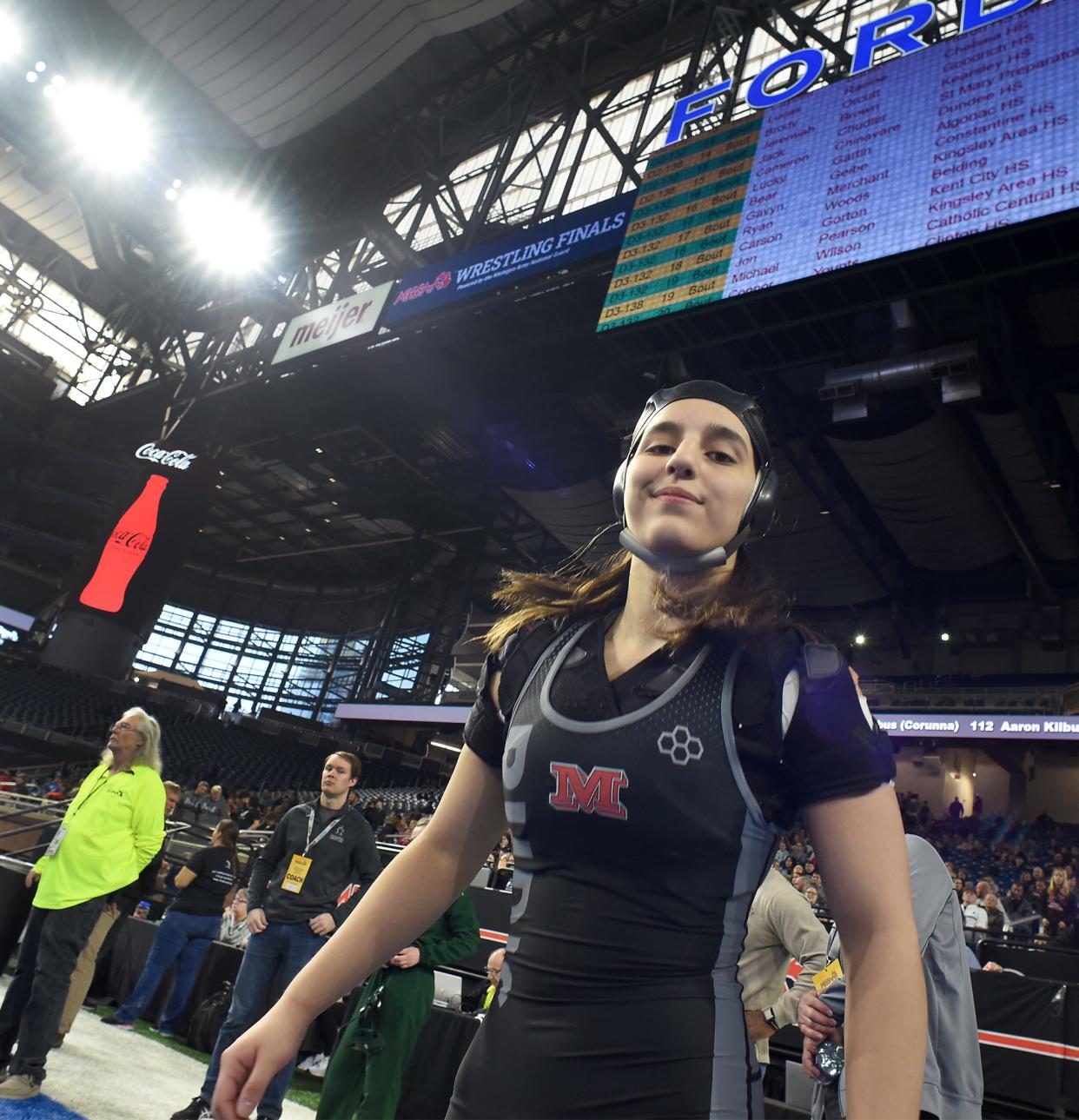 Milan's Angelina Pena gets ready for her first match during the MHSAA State Individual Wrestling Championships at Ford Field in Detroit on Friday, March 1, 2024.