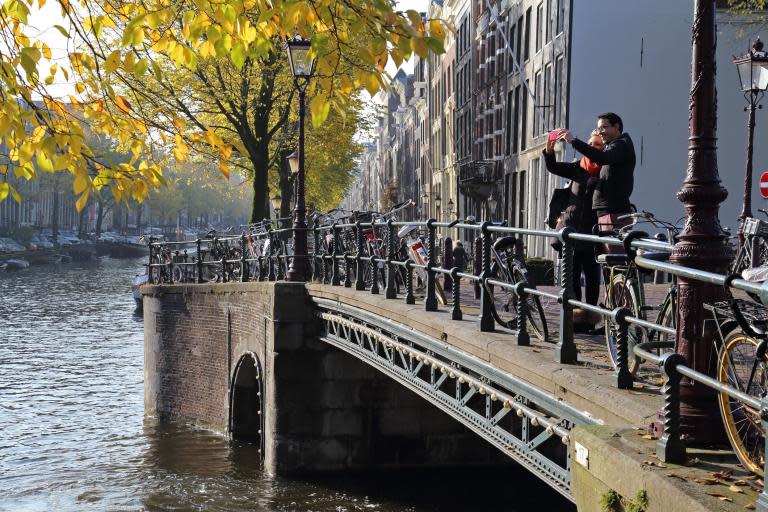 Amsterdam tourists can marry a local for a day, go on a date while weeding or pluck and eat a city pigeon in a new initiative designed to combat the negative effects of overtourism.Visitor numbers to Amsterdam are predicted to jump to almost 29 million over the next decade, from 19 million currently.Just one million people live in the Dutch capital, which announced earlier in May that it would stop actively promoting tourism as it buckles under the weight of its visitors.An initiative called Untourist Amsterdam has been set up as a way to give growing numbers of visitors a way to contribute positively to the city.The group runs a number of activities, co-founder Sabine Minsk told The Independent, to turn consumers into “changemakers” for Amsterdam.One of those activities is “Marry An Amsterdammer”, where a local and a visitor are matched up for a wedding ceremony, complete with rings, vows and proper attire. The ceremony takes around 35 minutes, said Minsk, and the "honeymoon" is spent exploring lesser-known spots in the city.The marriage is is symbolic rather than legally binding. "It's a chance for a visitor to have a meaningful encounter with a local," Minsk told The Independent.Other quirky activities include “weed dating”, where a visitor is matched with a local to know each other while pulling out weeds at an urban farm; walking a local elderly person around a park; or plucking and eating a city pigeon at a local artists' studio.The movement launches next week, which is when the first "weddings" are slated to take place.