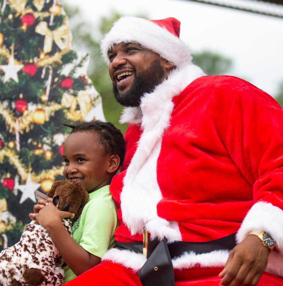 DaCory Curry, 4, of Des Moines, smiles as he sits with Santa during the Salvation Army's second annual "Christmas in July" event at Evelyn Davis Park  Saturday, July 16, 2022 in Des Moines. The free event offered Iowans family-friendly summertime activities while simultaneously spreading awareness about mortgage, rent, utilities and food assistance through the Salvation Army's social services and Pathway of Hope programs.
