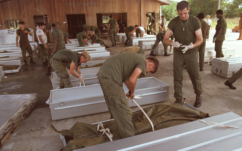 Soldiers clean up the bodies after the mass suicide at Jonestown. Source: Getty Images