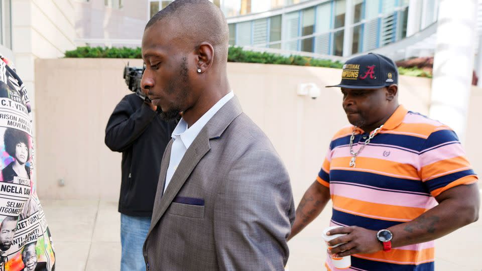 Victims Michael Corey Jenkins, left, and Eddie Terrell Parker enter the Thad Cochran US Courthouse in Jackson, Mississippi, to attend a Wednesday sentencing hearing for an ex-deputy who tortured them. - Rogelio V. Solis/AP